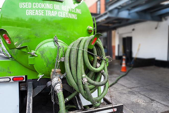 a service truck pumping grease from a restaurant's grease trap in Andover